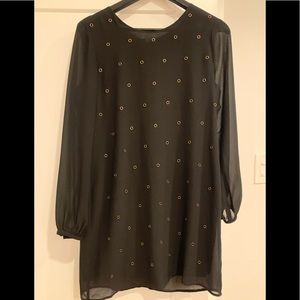 Like new condition black tunic dress with sheer sleeves and brass grommets